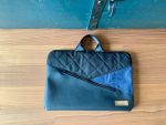 Die Laptoptasche fühlt sich leicht und weich an. Es hat ein Hauptfach mit Unterteilung und ein Münzfach mit Reissverschluss